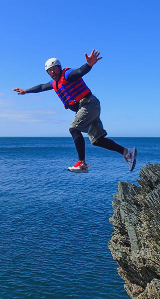 Man appears to be levitating as he jumps off a cliff