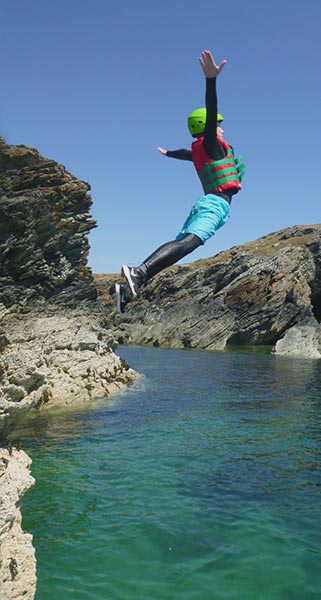 Coasteering group after a jump in white frothy water